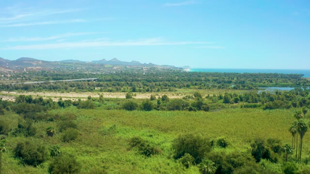 SAN JOSE DEL CABO BCS MEXICO-2021: Panning View of Coastal Plain with Road and Water