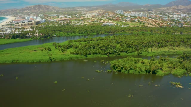 SAN JOSE DEL CABO BCS MEXICO-2021: River and Lush Green Islands with Urban Background
