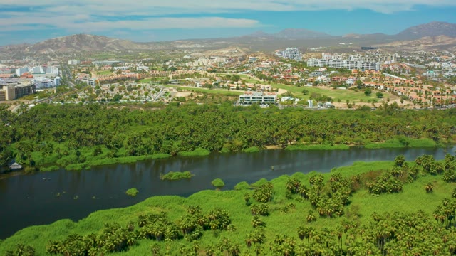SAN JOSE DEL CABO BCS MEXICO-2021: Clouds Drifting Over River and Urban Greenery