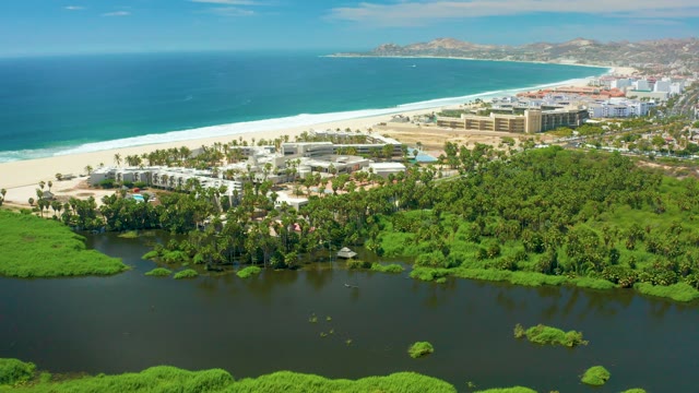 SAN JOSE DEL CABO BCS MEXICO-2021: Coastal Lagoon and Sandy Beach with Distant Buildings