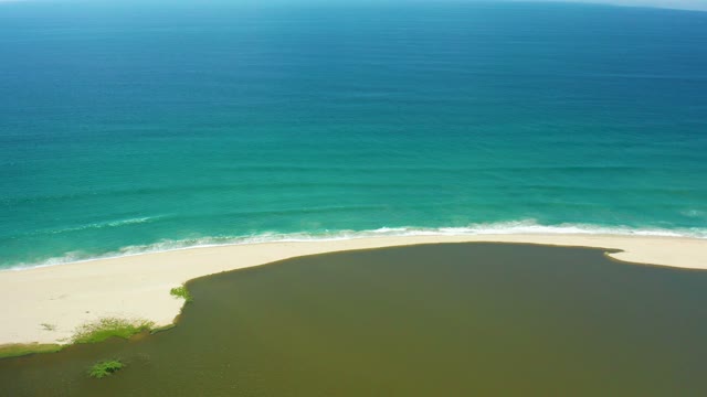 SAN JOSE DEL CABO BCS MEXICO-2021: River Merging with Ocean at Sandy Shoreline