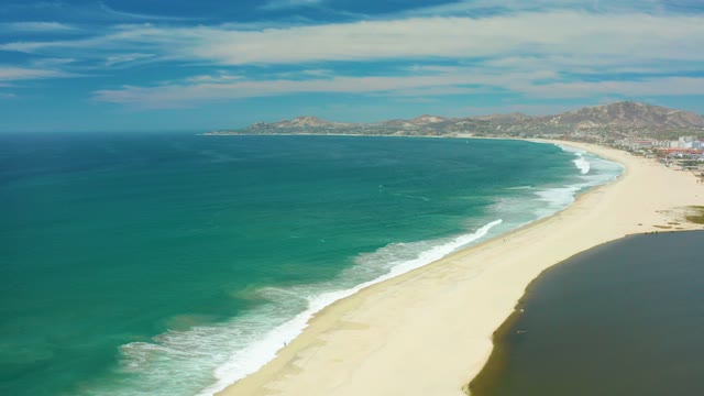 SAN JOSE DEL CABO BCS MEXICO-2021: Gentle Ocean Waves Rolling Onto Sandy Shore