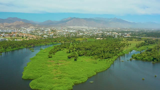 SAN JOSE DEL CABO BCS MEXICO-2021: Lush River Island with City and Mountain Backdrop