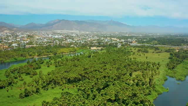 SAN JOSE DEL CABO BCS MEXICO-2021: River Meandering Through Lush Fields and Forested Areas