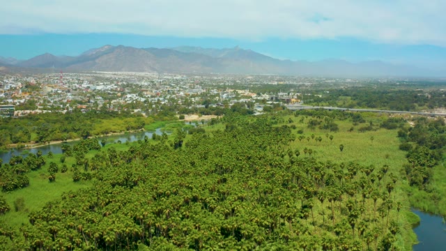 SAN JOSE DEL CABO BCS MEXICO-2021: Rural River, Fields, and Distant Town with Mountains