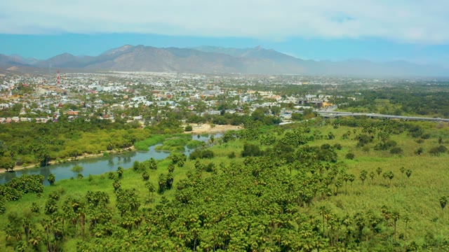SAN JOSE DEL CABO BCS MEXICO-2021: Riverside Town and Lush Fields Aerial Pan