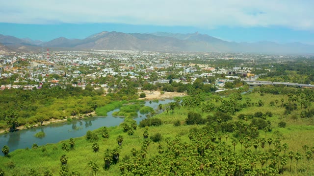 SAN JOSE DEL CABO BCS MEXICO-2021: Aerial Pan of River, Fields, and Distant Town