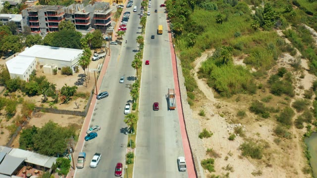 SAN JOSE DEL CABO BCS MEXICO-2021: Vehicles Traveling on a Multi-Lane Road with Buildings