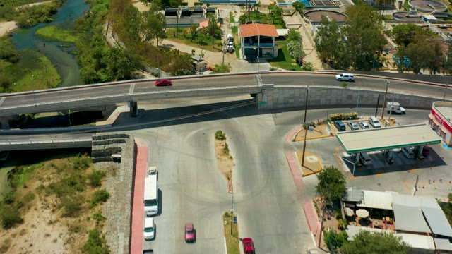 SAN JOSE DEL CABO BCS MEXICO-2021: Bridge Over River with Moving Traffic and Industrial Area
