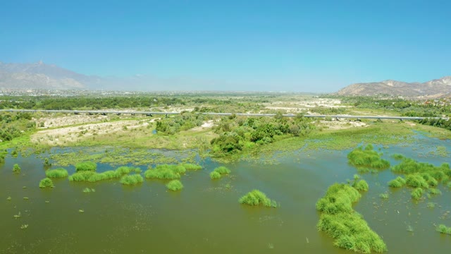 SAN JOSE DEL CABO ESTUARY BCS MEXICO-2021: Wetland and Highway with Moving Vehicles