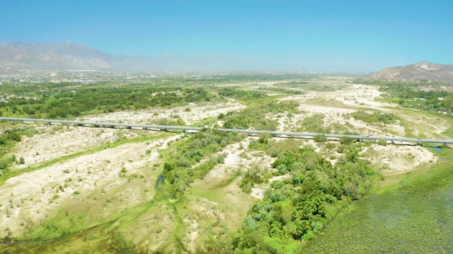 SAN JOSE DEL CABO ESTUARY BCS MEXICO-2021: Train Moving Across Bridge over Dry Terrain