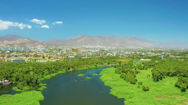SAN JOSE DEL CABO ESTUARY BCS MEXICO-2021: River Winding Through Lush Valley and Urban Area