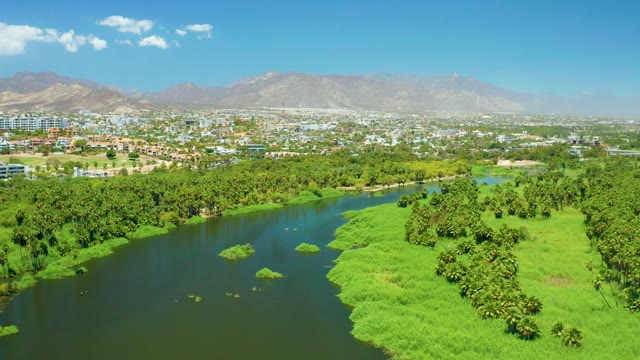 SAN JOSE DEL CABO ESTUARY BCS MEXICO-2021: River Winding Through Green Landscape and City
