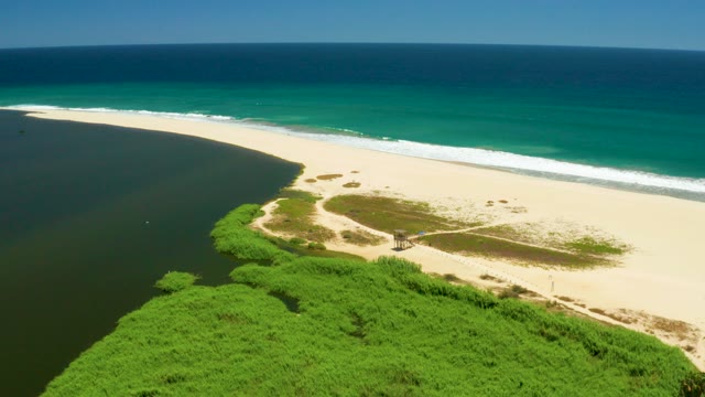 SAN JOSE DEL CABO ESTUARY BCS MEXICO-2021: Sandy Beach and Inlet with Boat Moving in Water