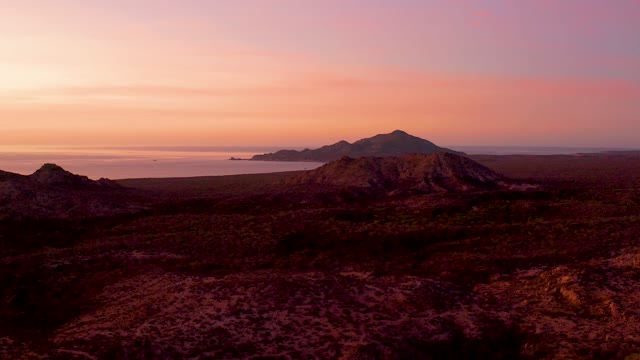 CABO PULMO BCS MEXICO-2021: Sunset Over Mountainous Desert Coastline with Moving Boat