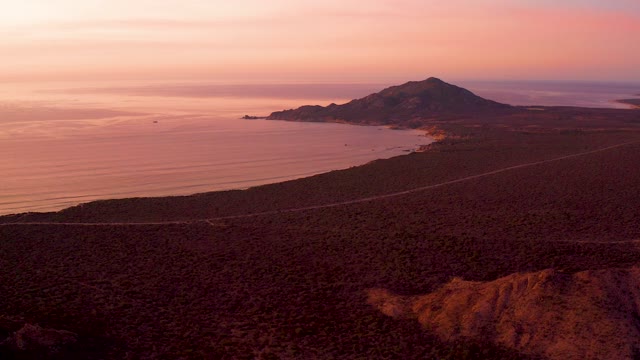CABO PULMO BCS MEXICO-2021: Coastal Road at Sunset with Vehicle Passing
