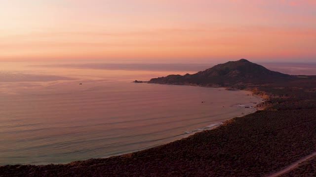 CABO PULMO BCS MEXICO-2021: Gentle Ocean Waves and Small Boat at Sunset Coast