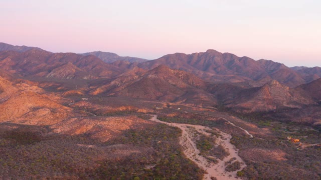 CABO PULMO BCS MEXICO-2021: Desert Road Winding Through Mountain Ranges at Dusk