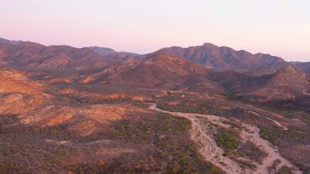 CABO PULMO BCS MEXICO-2021: Vehicle Moving on Desert Road Through Mountainous Landscape