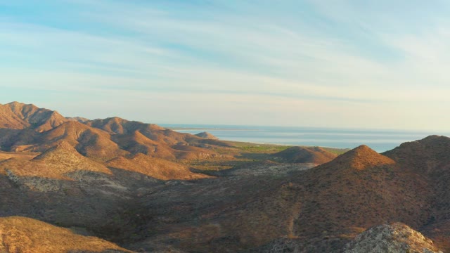 CABO PULMO BCS MEXICO-2021: Aerial Pan of Mountain Ranges and Distant Water