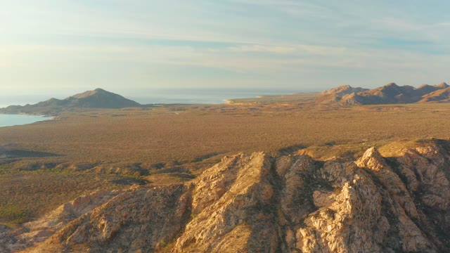 CABO PULMO BCS MEXICO-2021: Arid Rocky Landscape with Distant Mountains and Ocean