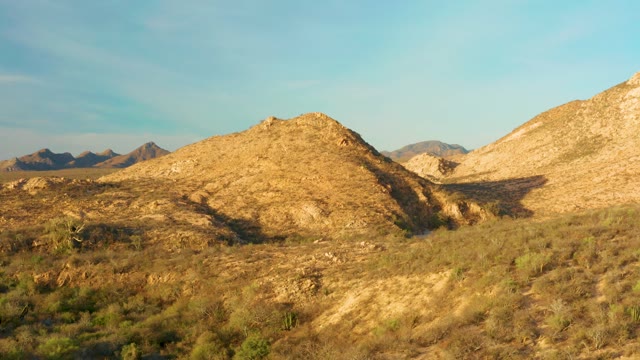 CABO PULMO BCS MEXICO-2021: Desert Hills and Sparse Vegetation Under Shifting Sunlight
