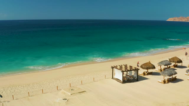 HILTON LOS CABOS MEXICO-2021: Sandy Beach with Thatched Umbrellas and Ocean Waves