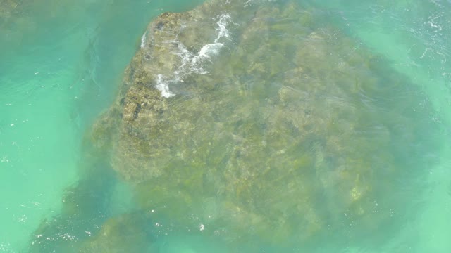 HILTON LOS CABOS MEXICO-2021: Waves Breaking on a Submerged Rock in Turquoise Water