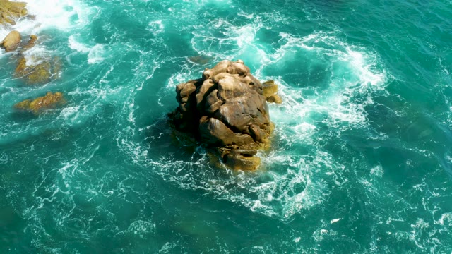 HILTON LOS CABOS MEXICO-2021: Waves Crashing Around a Rocky Outcrop in Turquoise Water