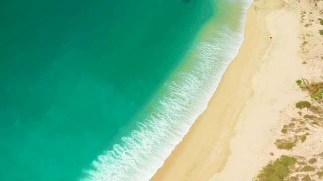 HILTON LOS CABOS MEXICO-2021: Ocean Waves Rolling Onto Sandy Beach From Above