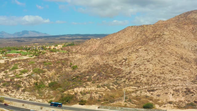 HILTON LOS CABOS MEXICO-2021: Desert Highway with Moving Vehicles and Arid Hills