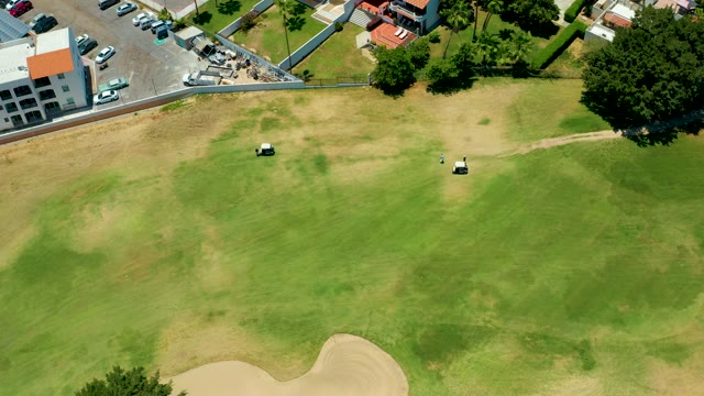 SAN JOSE DEL CABO BCS MEXICO-2021: Two Golf Carts Moving on a Golf Course