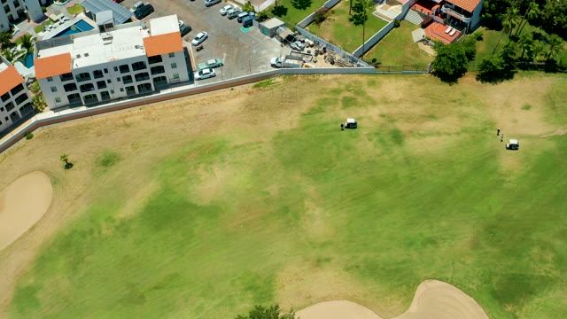 SAN JOSE DEL CABO BCS MEXICO-2021: Golf Carts Moving Across a Green From Above