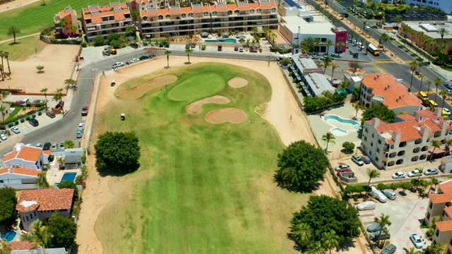 SAN JOSE DEL CABO BCS MEXICO-2021: Golf Cart Moving on Course Near Residential Area