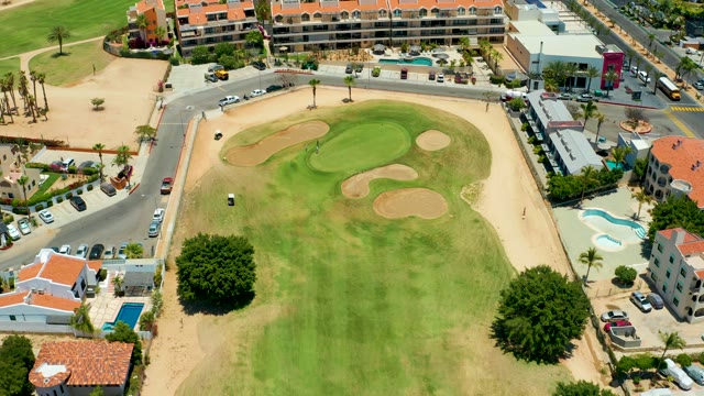 SAN JOSE DEL CABO BCS MEXICO-2021: Golf Green with Moving Cart and Road Traffic