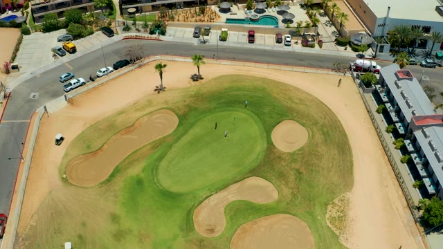 SAN JOSE DEL CABO BCS MEXICO-2021: Golf Green and Sand Bunkers with Moving Traffic