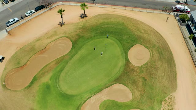 SAN JOSE DEL CABO BCS MEXICO-2021: Golfers and Cart Moving on a Golf Green