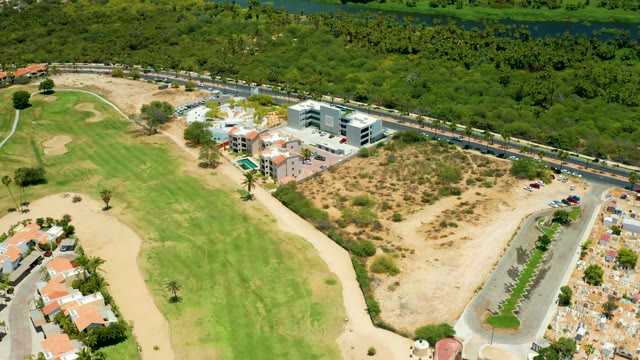 SAN JOSE DEL CABO BCS MEXICO-2021: Golf Course with Moving Vehicles on Adjacent Road