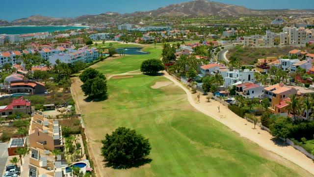 SAN JOSE DEL CABO BCS MEXICO-2021: Golf Course with Coastal Buildings and Ocean Backdrop