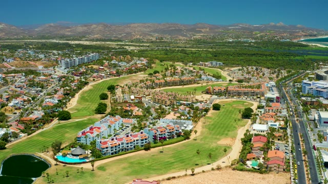 SAN JOSE DEL CABO BCS MEXICO-2021: Golf Course, Residential Buildings, and Moving Vehicle on Road