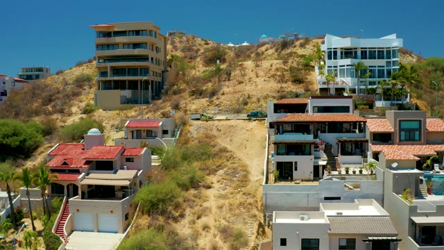 SAN JOSE DEL CABO BCS MEXICO-2021: Hillside Residential Area with Moving Vehicles