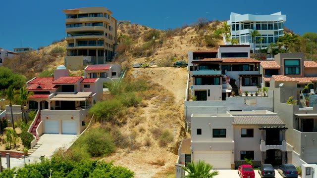 SAN JOSE DEL CABO BCS MEXICO-2021: Hillside Buildings with Wind-Blown Vegetation