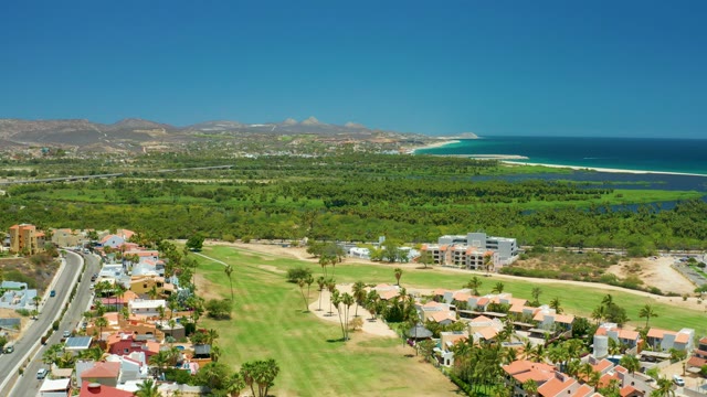 SAN JOSE DEL CABO BCS MEXICO-2021: Car Driving Along Coastal Road with Golf Course