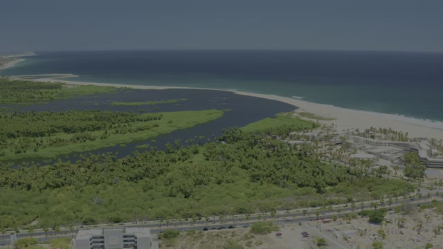 SAN JOSE DEL CABO BCS MEXICO-2021: Coastal Inlet, Sandy Beach, and Moving Road Traffic