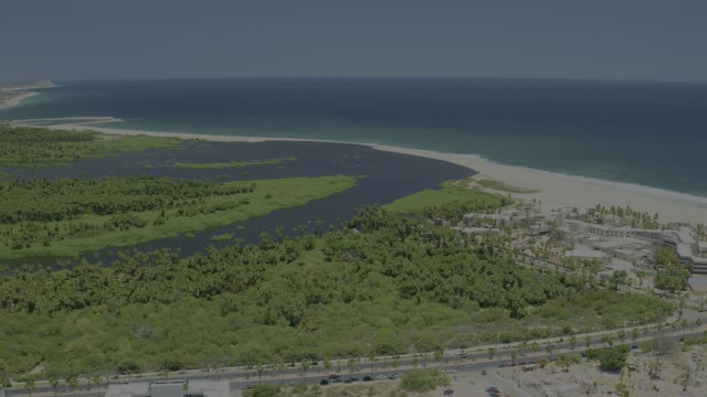 SAN JOSE DEL CABO BCS MEXICO-2021: Estuary Flowing Into Ocean with Sandy Beach and Road