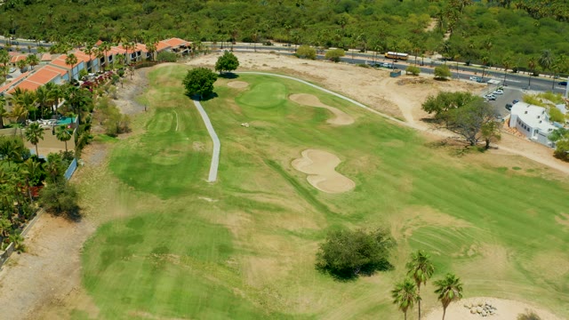 SAN JOSE DEL CABO BCS MEXICO-2021: Golf Course with Moving Vehicles on Adjacent Road