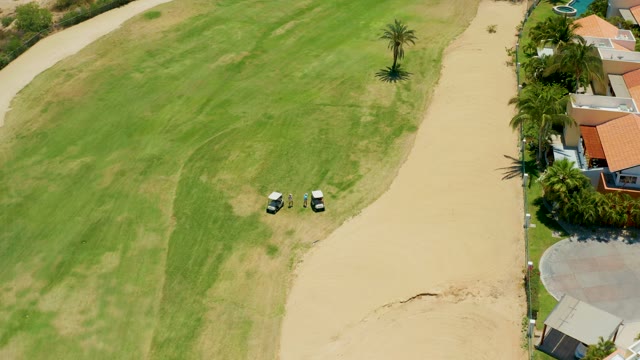 SAN JOSE DEL CABO BCS MEXICO-2021: Golf Carts Traveling on Grassy and Sandy Path