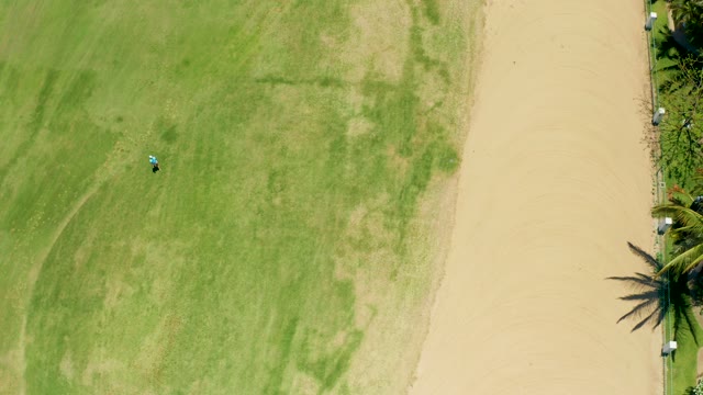 SAN JOSE DEL CABO BCS MEXICO-2021: Small Vehicle Moving Across Grassy Field with Sandy Path