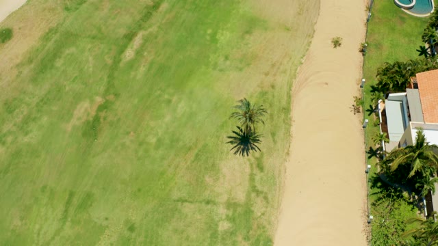 SAN JOSE DEL CABO BCS MEXICO-2021: Drone Flight over Grassy Field and Residential Area