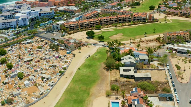 SAN JOSE DEL CABO BCS MEXICO-2021: Vehicle Moving on Road Near Tents and Buildings